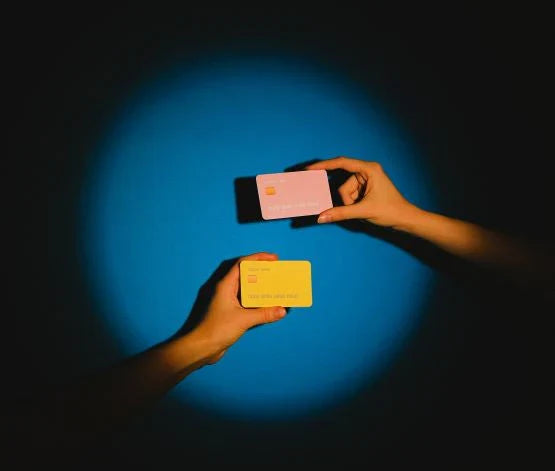 Two credit cards on a dark background