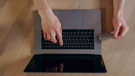 Credit card number being typed into a laptop