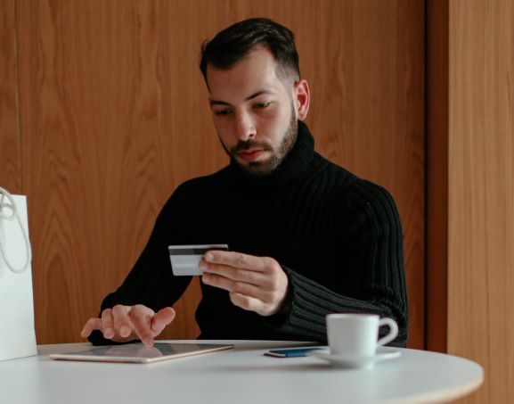 man-white-active-credit-card-on-tablet-coffee-wallet-cash-money