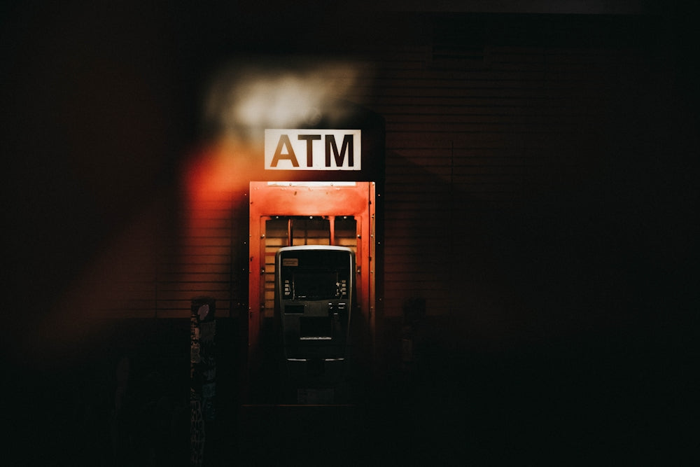 Building with an illuminated ATM sign at night