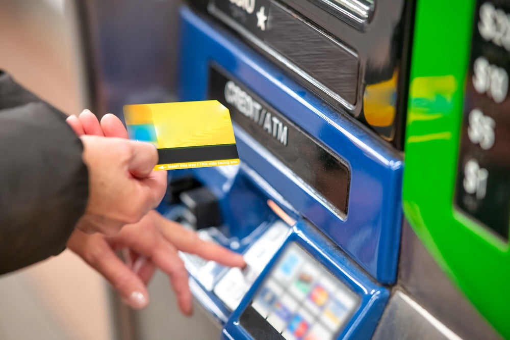 Person paying with a card at a payment machine