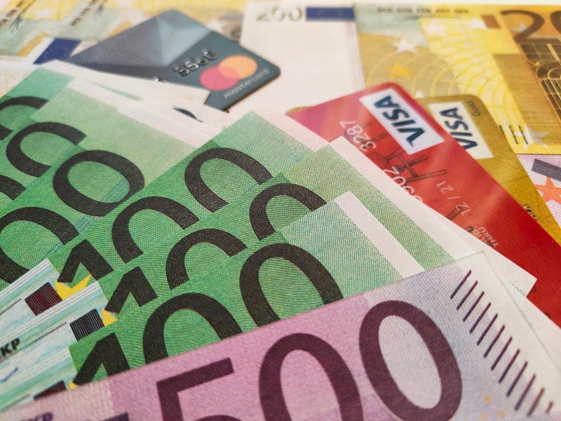 Credit card tucked into a stack of cash